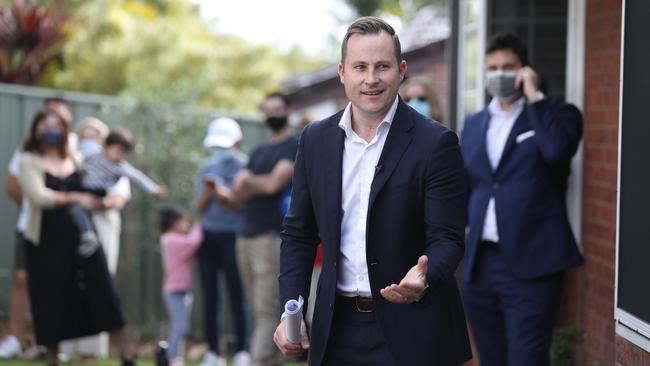 Auctioneer Justin Nickerson with bidders in Carindale, Brisbane, on Saturday. Picture: Annette Dew