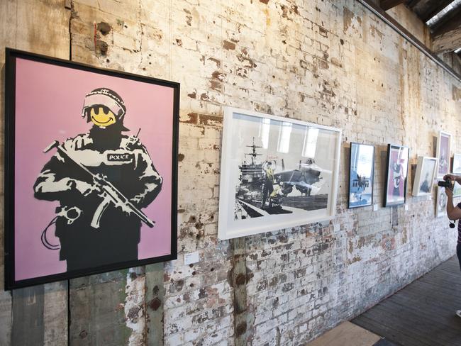 Banksy artworks on display in Sydney in 2011. The artist’s works now sell for huge sums, although his identity remains a mystery. Picture: Charles Brewer