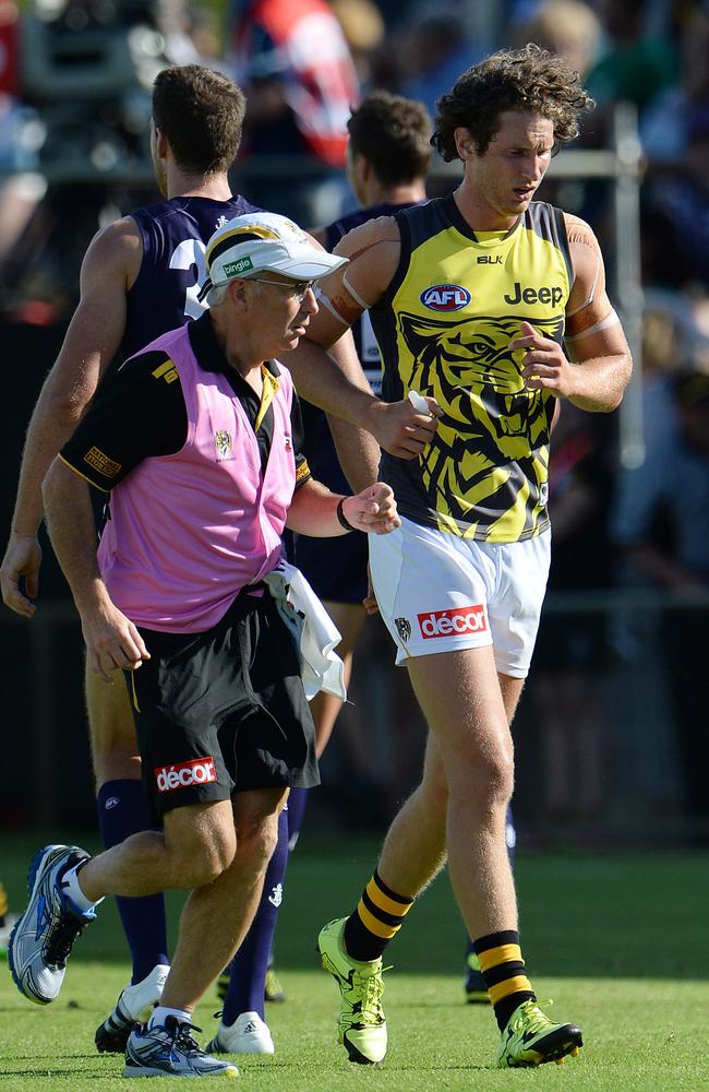 Ty Vickery leaves the field with a trainer after fainting during last weekend’s NAB Challenge match against Fremantle. Picture: Daniel Wilkins