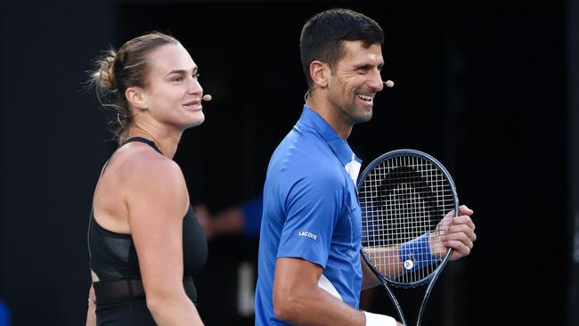 Reigning Australian Open champions Aryna Sabalenka and Novak Djokovic played mixed doubles together during a charity event on Rod Laver Arena on Thursday night. Picture: David Gray/AFP