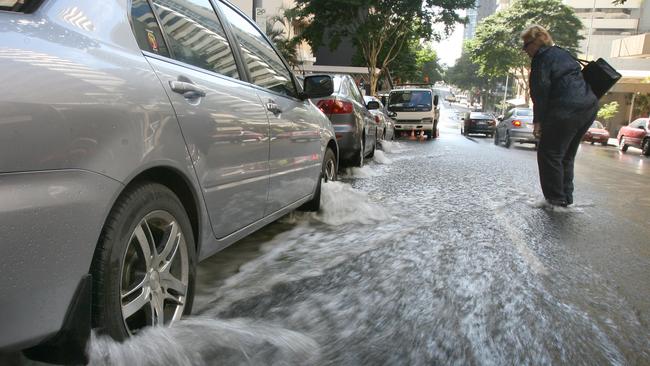 A burst water main on Mary Street in Brisbane city floods the street. Picture: File.