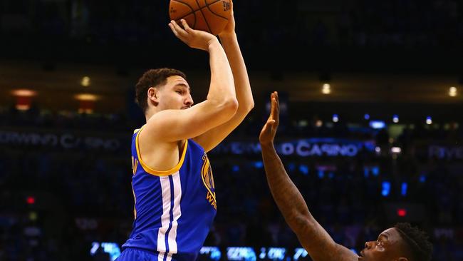 Klay Thompson of the Golden State Warriors shoots the ball against Anthony Morrow #2 of the Oklahoma City Thunder during the second half.