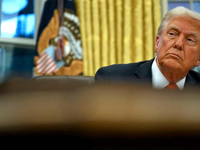 US President Donald Trump speaks looks on after signing an executive order in the Oval Office of the White House on February 10, 2025, in Washington, DC. (Photo by ANDREW CABALLERO-REYNOLDS / AFP)