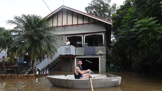 Flooding has long been a problem in Lismore. Lennon Bartlett paddles a rowboat to his parents house on March 31, 2017. Picture: AAP Image/Dave Hunt