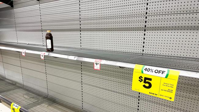 Shelves for toilet paper left empty at Granville Woolworths, Sydney. Picture: NCA NewsWire / Dylan Robinson