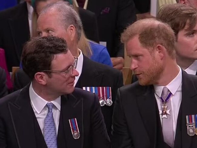 Jack Brooksbank listens as Prince Harry lets loose.