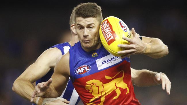 Brisbane captain Dane Zorko escapes the clutches of his North Melbourne opponent. Picture: AAP