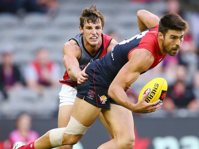 NAB Challenge: Melbourne v. Essendon at Etihad Stadium. Chris Dawes breaks the Freezer tackle . Pic: Michael Klein