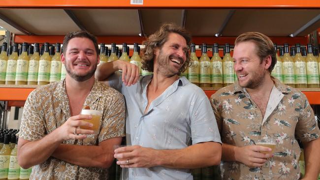 Mr Consistent owners, Jarrad Bell, Michael Sebire and Jeremy Davidson, toast the success of their ready made cocktails mix, at the company factory at Burleigh. Picture: Glenn Hampson