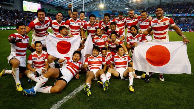 Japan's players celebrate after their victory against South Africa in a Rugby World Cup Pool B match at the Brighton Community Stadium, Brighton, England, Saturday Sept. 19, 2015. (Gareth Fuller/PA via AP) UNITED KINGDOM OUT NO SALES NO ARCHIVE