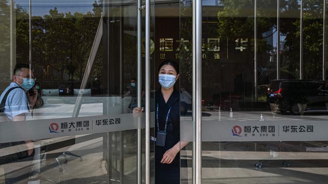 A worker stands by the entrance of the Evergrande Center building in Shanghai on September 22. Picture: AFP