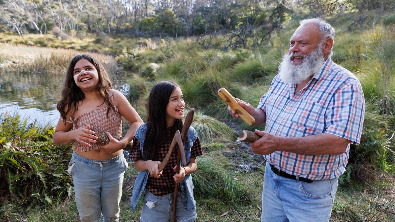 Indigenous elder Uncle Col Locke passing on his culture with Miki May Williams, 11, and her sister Joowal, 9, in the Blue Mountains. Picture: David Swift