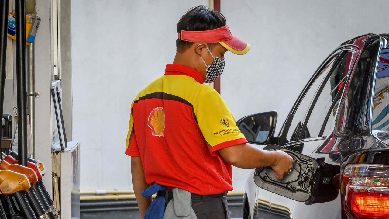 Experts recommend that people should now wear gloves when filling up their cars with petrol, as COVID-19 lives the longest on metal and plastic surfaces. Picture: Mladen Antonov/AFP