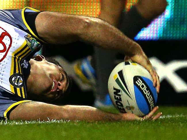 Kane Linnett of the Cowboys scores a try in the tackle of Kiti Glymin during the round 17 NRL match between the St George Illawarra Dragons and North Queensland Cowboys, at WIN Stadium, Wollongong, Australia, on Saturday 04 July, 2015. Photo: Renee McKay/Daily Telegraph