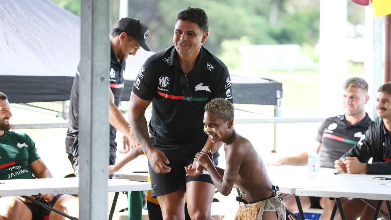 South Sydney Rabbitohs player Latrell Mitchell is dragged up to dance by Joseph Atkinson, 11, of the Buri Guman dance group from Yarrabah State School at Yarrabah's Jilara Oval. Picture: Brendan Radke