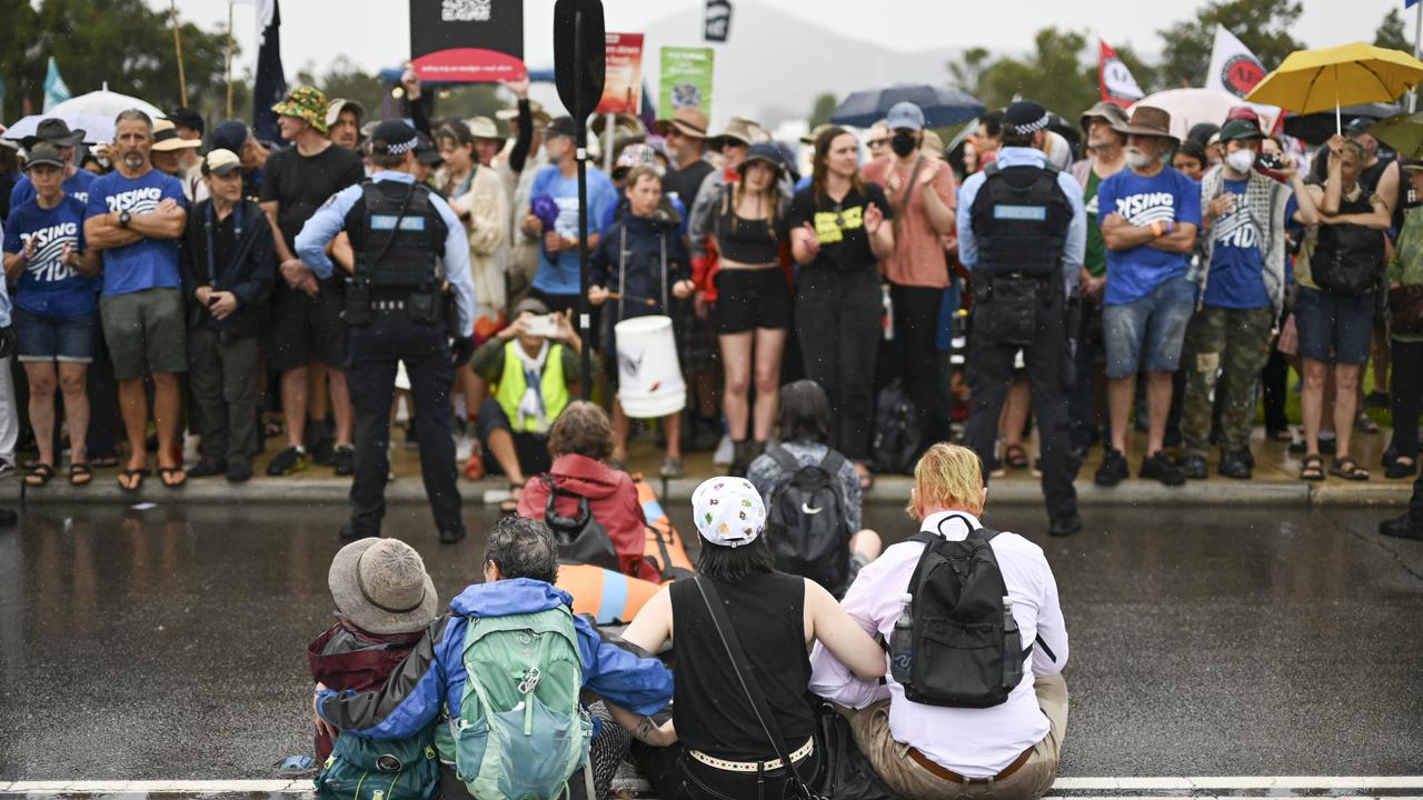 NewsWire heard one activist, a middle-aged woman, shouting ‘climate justice now’ as she was carried away by her arms and legs. Picture: NewsWire / Martin Ollman