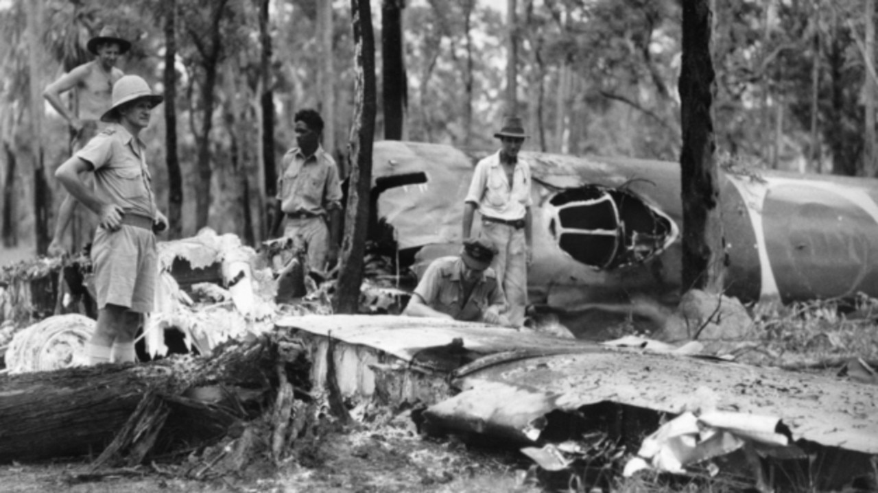 Bombing of Darwin: RAAF personnel and an Aboriginal guide examine the wreckage of aJapanese 'Betty' bomber aircraft shot down by Squadron Leader R C Cresswell during a night attackon 23 November 1942 on Darwin. The bodies of nine Japanese were later found near the wreckedaircraft.