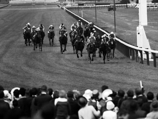 Punters cheers on the runners at the 1965 Melbourne Cup. File picture