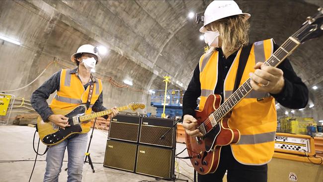 Powderfinger guitarists Darren Middleton and Ian Haug play songs in the Cross River Rail tunnel where Albert Street Station will be.