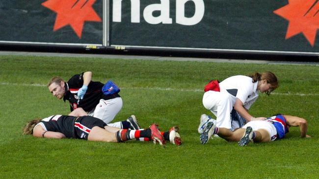 Justin Koschitzke (l) and Daniel Giansiracusa (r) with trainers after their massive collision in 2006.