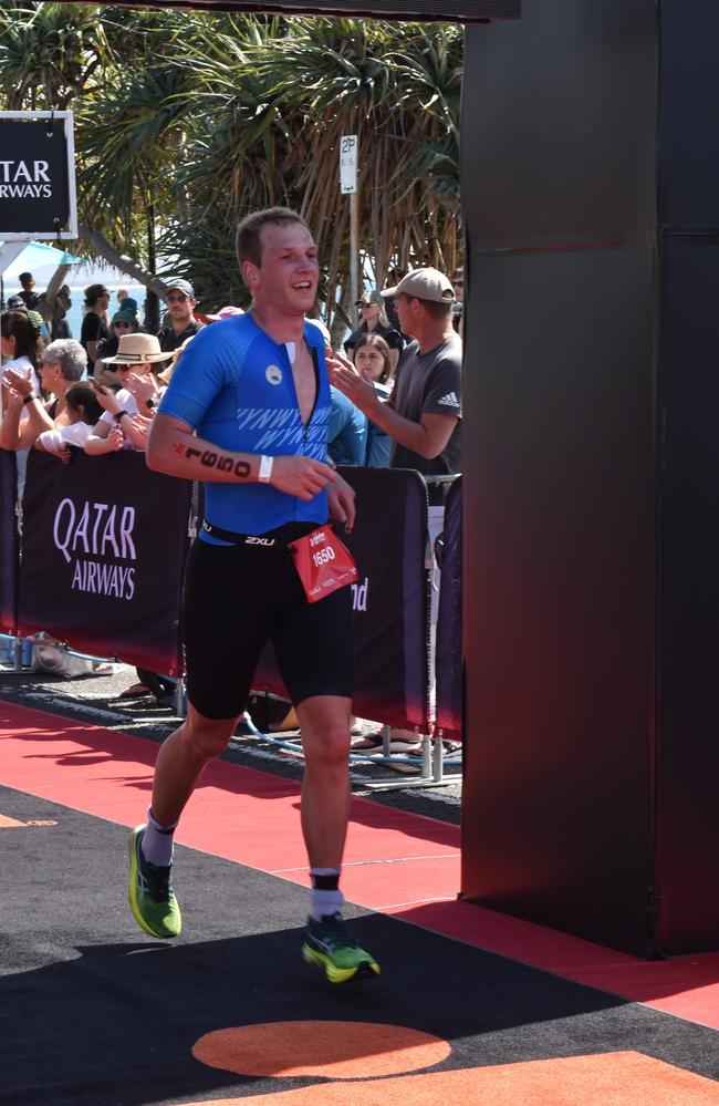 Athletes crossing the finish line at the Sunshine Coast Ironman 70.3 2023.