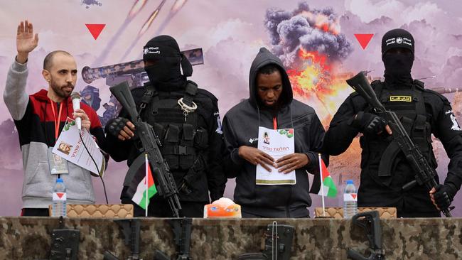 Israeli hostages Tal Shoham, far left, and Avera Mengistu, second from right, stand on a stage in Rafah during their release by Hamas. Picture: AFP