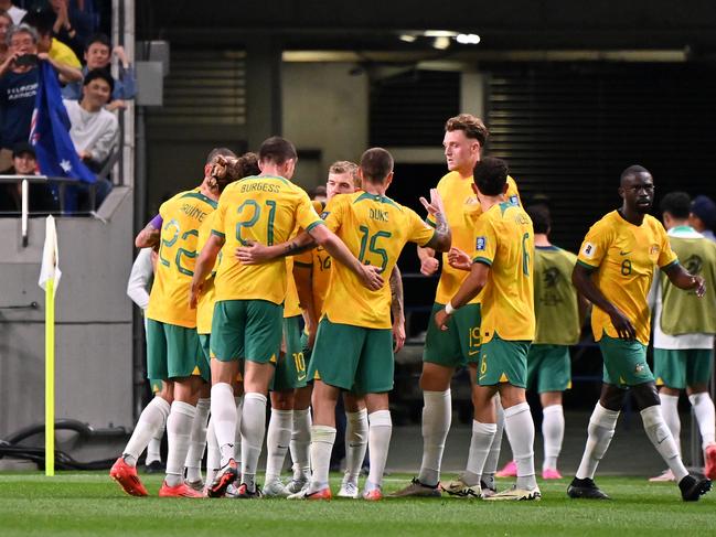 The Socceroos celebrate taking the lead against Japan after an own goal from Shogo Taniguchi. Picture: Kenta Harada/Getty Images