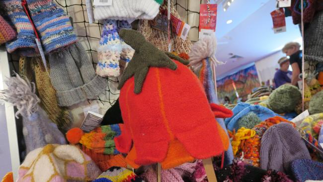 Dozens of volunteers are busy hanging thousands of beanies in preparation for the 28th Alice Springs Beanie Festival. Picture: Gera Kazakov