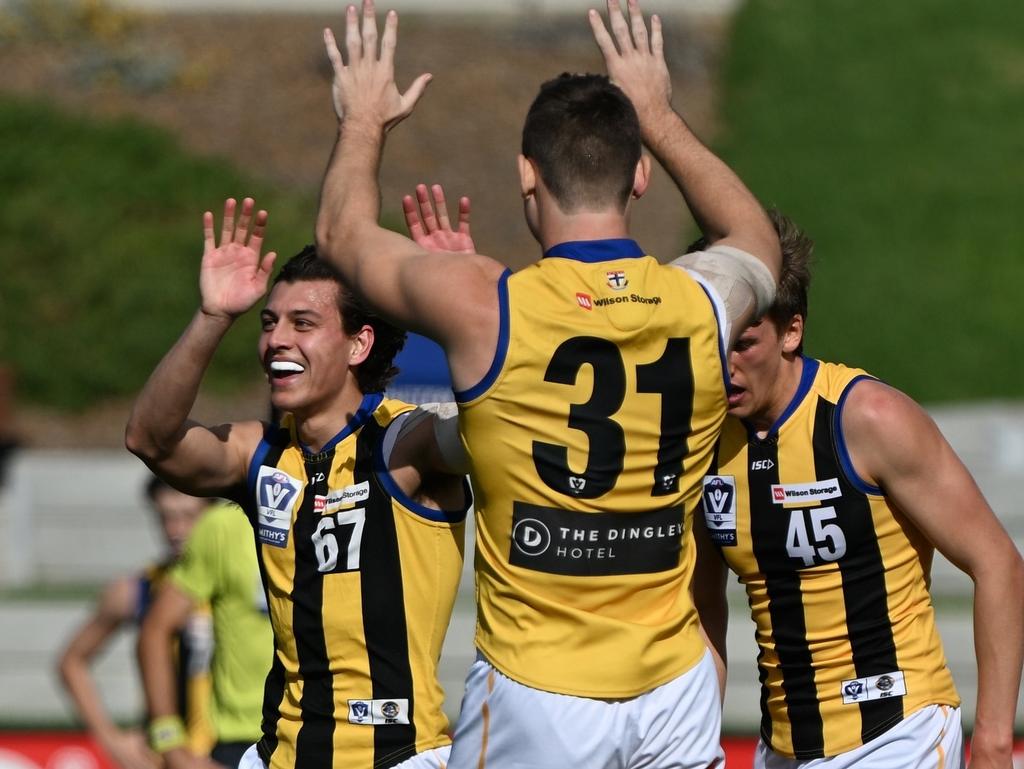 Sandy players celebrate a goal during their win over Footscray in Round 4.