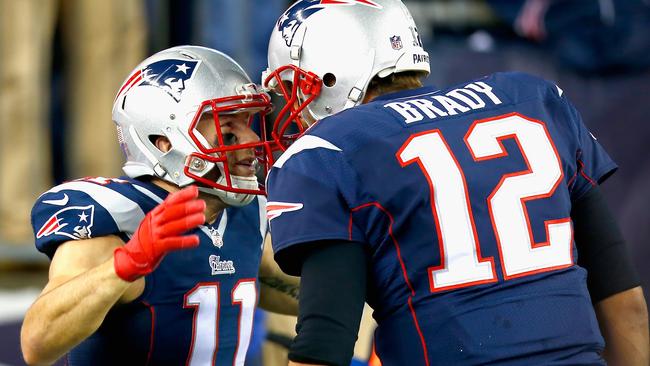 Julian Edelman #11 reacts alongside Tom Brady after returning a kick for a touchdown.