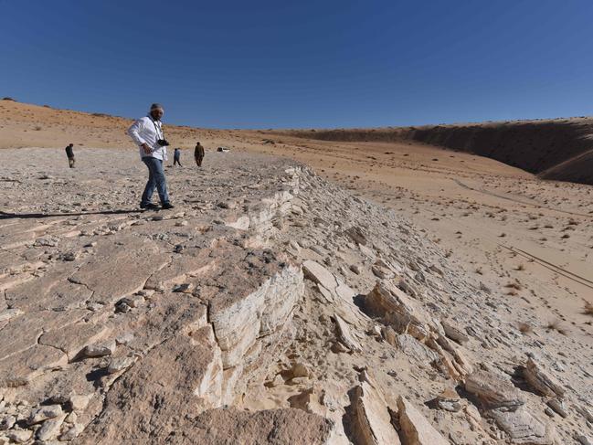 This undated handout photo obtained September 16, 2020 shows a view of the edge of the Alathar ancient lake deposit and surrounding landscape. - The humans may have hunted the big mammals but they did not stay long, using the watering hole as a waypoint on a longer journey. This detailed scene was reconstructed by researchers in a new study published in Science Advances on September 16, 2020, following the discovery of ancient human and animal footprints in the Nefud Desert that shed new light on the routes our ancient ancestors took as they spread out of Africa. (Photo by Badar ZAHRANI / Badar ZAHRANI / AFP) / RESTRICTED TO EDITORIAL USE - MANDATORY CREDIT "AFP PHOTO /BADAR ZAHRANI/HANDOUT " - NO MARKETING - NO ADVERTISING CAMPAIGNS - DISTRIBUTED AS A SERVICE TO CLIENTS / TO GO WITH AFP STORY BY ISSAM AHMED -"Ancient footprints in Saudi Arabia show how humans left Africa'