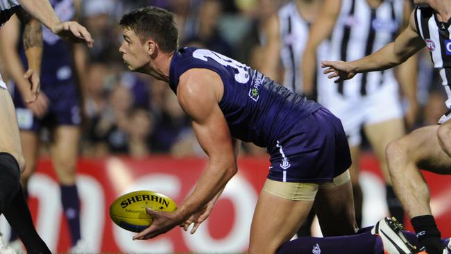 Fremantle's Jack Hannath gets a handball away.