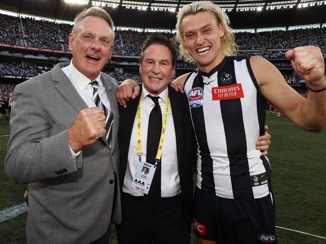 President Jeff Browne (centre) with Darcy and Pete Moore after Collingwood’s premiership win. Picture by Michael Klein