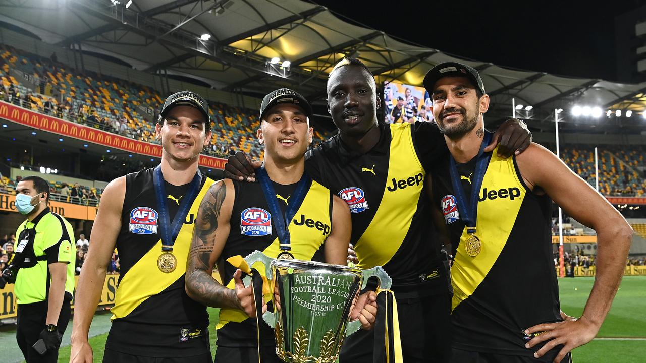 BRISBANE, AUSTRALIA – OCTOBER 24: Daniel Rioli, Shai Bolton, Mabior Chol and Marlion Pickett of the Tigers celebrate with the Premiership Trophy during the 2020 AFL Grand Final match between the Richmond Tigers and the Geelong Cats at The Gabba on October 24, 2020 in Brisbane, Australia. (Photo by Quinn Rooney/Getty Images)