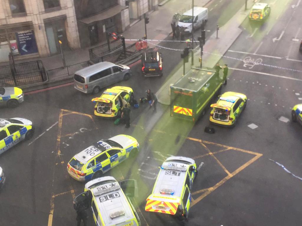 A handout picture shows members of the police and emergency services arriving at Monument tube station. Picture: Alexandru Ion.