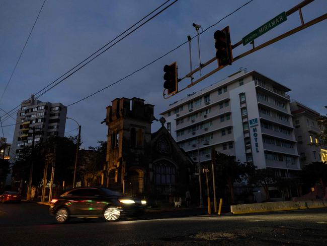 A car navigates through an intersection without stop lights in San Juan, Puerto Rico after a major power outage hit the island on December 31, 2024. Picture: AFP