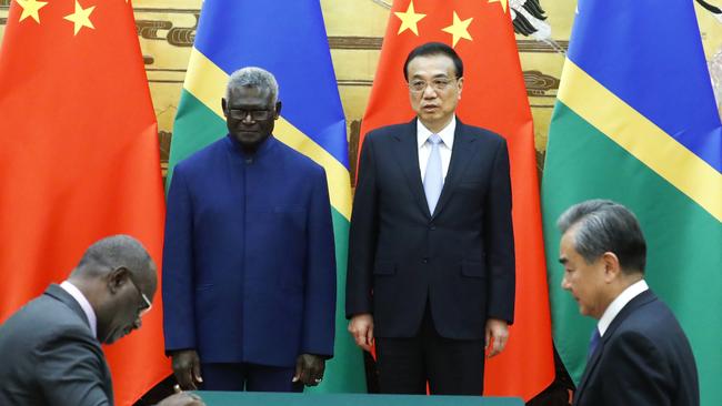 Solomon Islands Prime Minister Manasseh Sogavare, Solomon Islands Foreign Minister Jeremiah Manele, Chinese Premier Li Keqiang and Chinese State Councillor and Foreign Minister Wang Yi attend a signing ceremony at the Great Hall of the People.