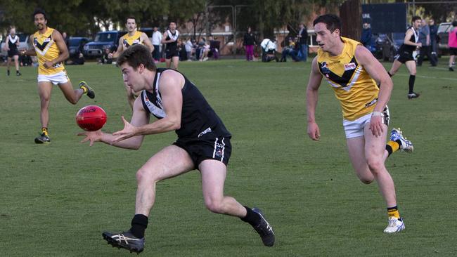 Adelaide University’s Hamish Wallace and Brighton’s Jack Plenty in action/ Wallace will be hoping to help Uni win its last minor round match. Picture: Emma Brasier