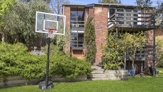 The tiered backyard creates usable flat space for the kids.