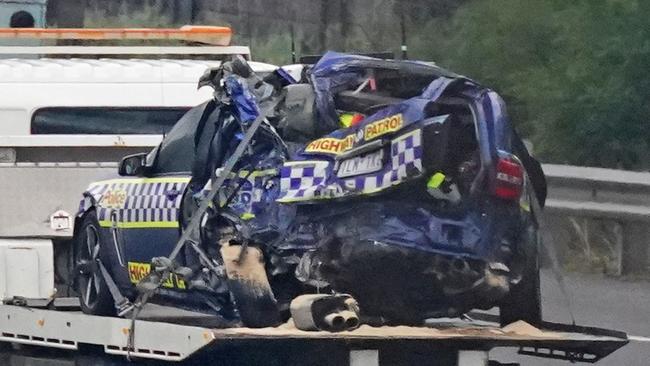 The damaged police car is towed from the scene. Picture: AAP