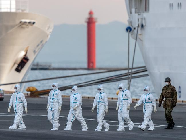 Japanese soldiers and emergency workers walk from the Diamond Princess. Picture: Getty