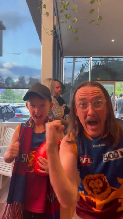 Brisbane Lions fans celebrating the premiers back home in Queensland