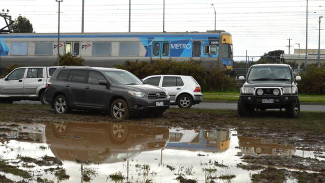 The waterlogged vacant land near Cranbourne railway station used as a carpark by commuters. Picture: Chris Eastman