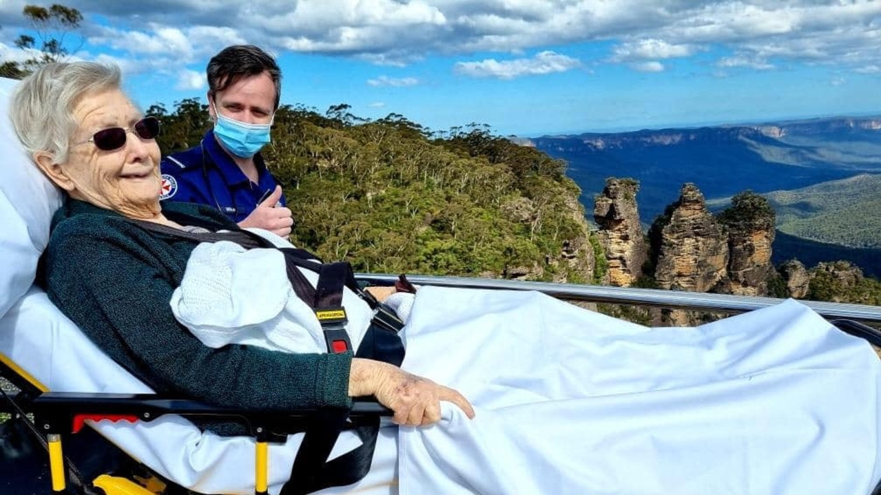 Two paramedics in NSW have granted one palliative care patient an extra special trip, taking her to the Three Sisters in the Blue Mountains for one last look. Picture: Ambulance NSW