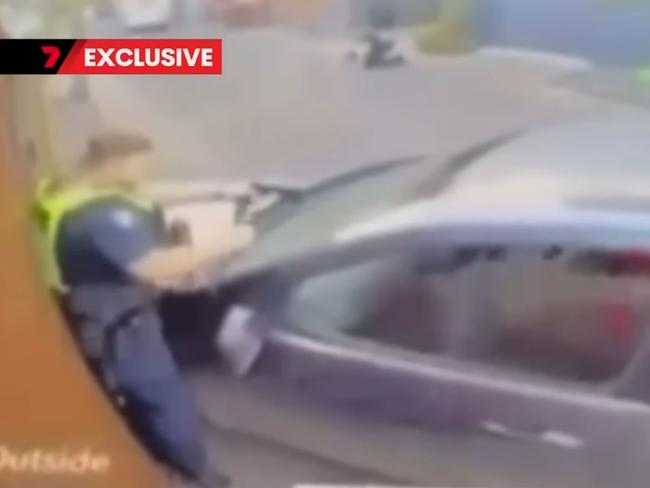 Footage of the policeman being pinned against the wall by a car. Picture: Channel 7