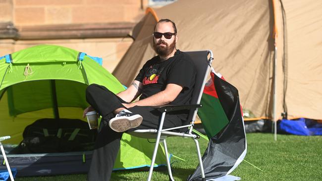 25-year-old Marley Liyanagama is vice president of USYD’s political economy society, and is “tag-teaming” with the rest of his contingent as the protesters prepare to bunker down for the long-haul. Picture: Jeremy Piper