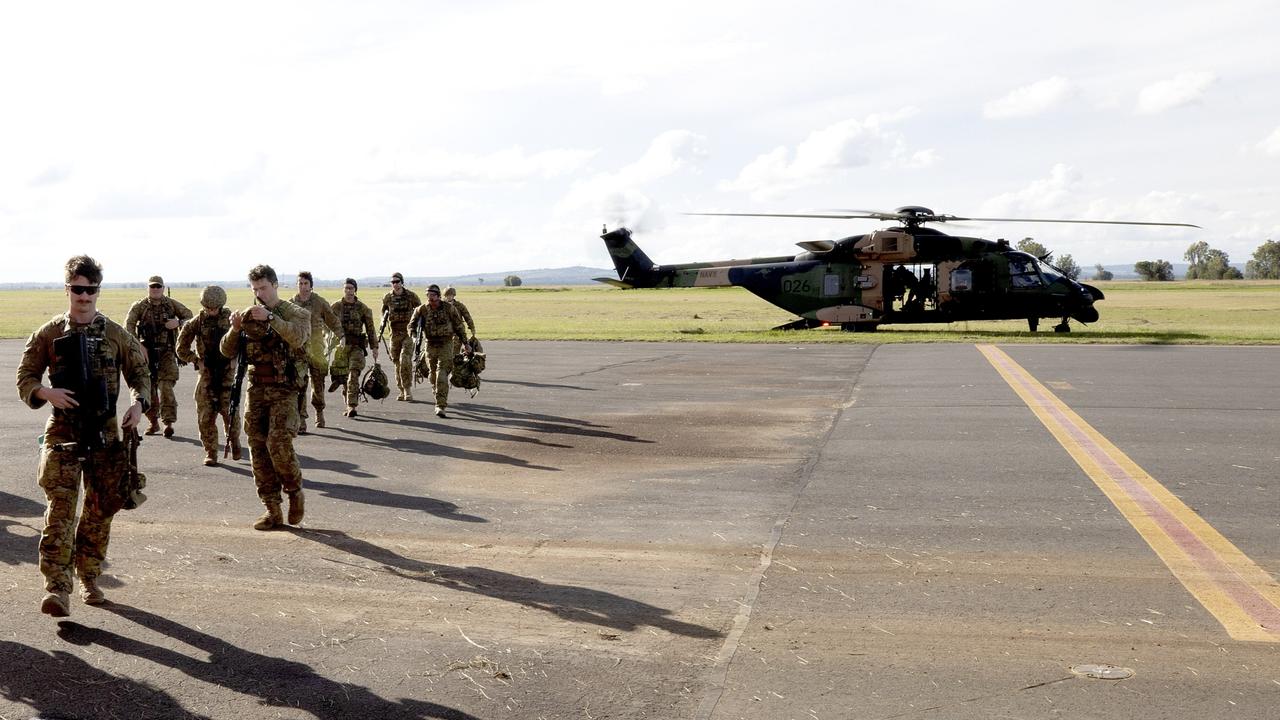 Australian Army soldiers from 11 Brigade Quick Response Force land in a MRH90 helicopter at the Oakey Army Aviation Centre.