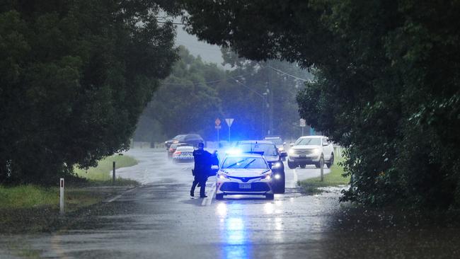 Queensland uniformed Police block the road on Tallebudgera Connection Road Tallebudgera at the back of Currumbin Creek after torrential rain over night caused the creek to break its banks. NCA NewsWire / Scott Powick
