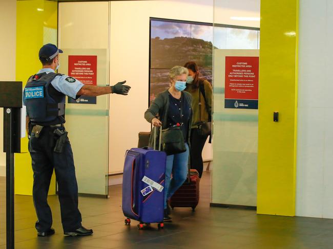 Arrivals from Covid 19 hotspots at Darwin International Airport enroute to mandatory Quarantine as Borders open to Interstate visitors.Picture GLENN CAMPBELL