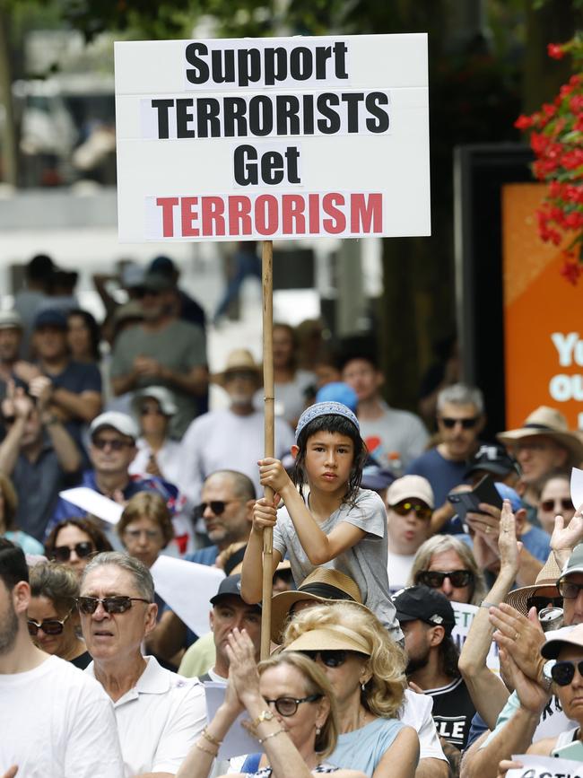 Protesters holding signs at the rally. Picture: Richard Dobson